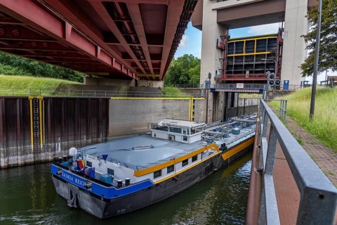 Cargo ship, tanker, leaves the port canal in the port of Duisburg-Ruhrort, enters the