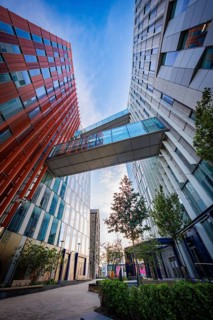 Two modern Google buildings with a glass connection and a bridge over it, urban ambiance, Docklands