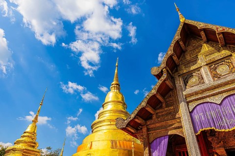 Gilded Chedi temple towers, stupas, prayer hall, in the Wat Phra Singh Buddhist temple complex,