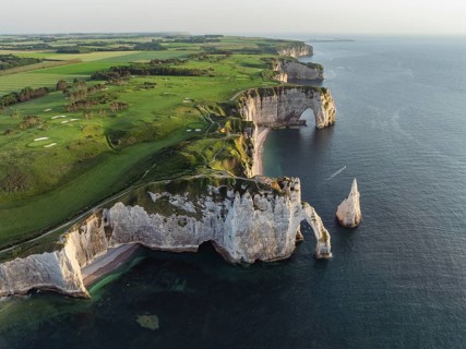 Aerial view of the Porte d'Aval rock formation in the evening sun, well-known sights on the chalk