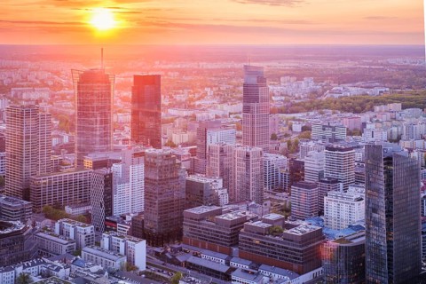 Broad view across the Warsaw skyline in Poland with skyscrapers, cityscape layers, shadowed