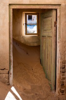 Interior view, doors and house full of sand, former diamond mining town, Namib Desert, Kolmanskop,
