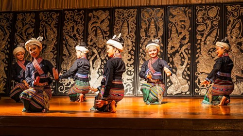 Young Thai women in traditional dress showing a traditional dance, Old Chiang Mai Cultural Center,