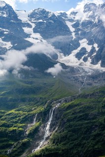 Schmadribachfall waterfall and picturesque mountain landscape with Breithorn mountain peak, Bernese