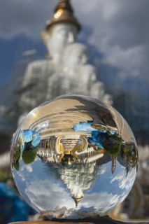 The five seated Buddhas (path to enlightenment) are reflected in a glass sphere, Wat Phra That Sorn