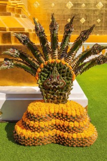 Green and orange intricately woven floral decoration in the Wat Phra Singh Buddhist temple complex,
