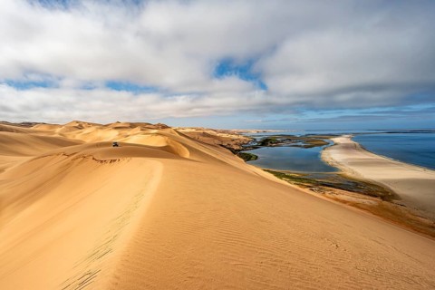 Sand dunes and sea in morning light, Atlantic coast and Namib desert, impressive desert landscape,