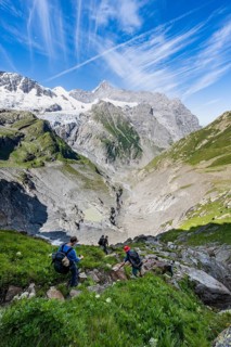 Mountaineers on a hiking trail, mountain panorama, picturesque high alpine mountain landscape with