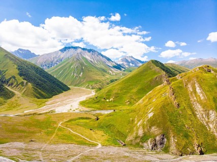 Panoramic views of green caucasus mountains and old tower ruins of ancient towers. Georgia and