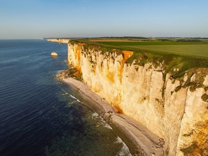 Aerial view of rugged chalk cliffs in the evening sun, Étretat, Alabaster Coast, La Côte d'Albâtre,