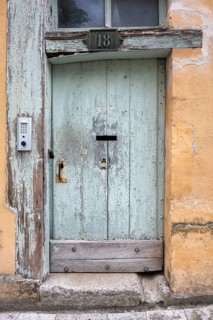 Old wooden door with a modern, digital door opener on a half-timbered house in the old town of