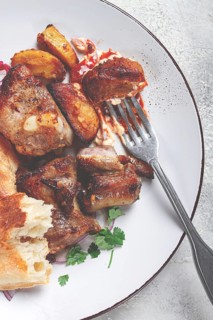A plate with leftover pork kebab, with bread, on a white plate, close-up, there are no people