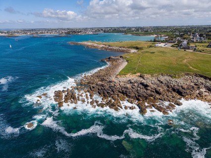Aerial view of a rugged, rocky Atlantic coast, Breton coast, with rolling waves and deep blue