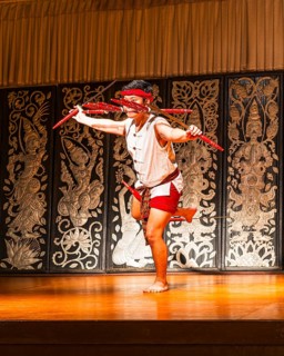 Young Thai man in traditional clothing in a historic show with knives and swords, Old Chiang Mai