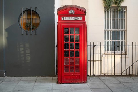 A classic red telephone box stands on a street, Westminster, London, Great Britain, England, Great