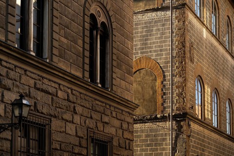 Historic buildings with detailed brick façade in warm evening light, old town, Florence, Tuscany,