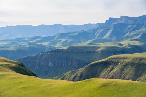 Green fields and mountains, cathedral range mountainous landscape, Drakensberg Mountains,