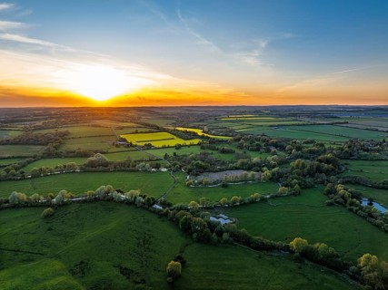 Sunset of Fields and Farms over Horsebridge nad Stockbridge from a drone, Hampshire, England,