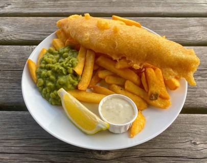 Fish and chips, fried fish in batter, french fries, pea puree, remoulade, lemon, on a plate, food,