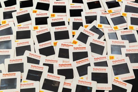 Old loosely arranged 1980s 35mm Kodak Kodachrome slides mounted in white cardboard frames with