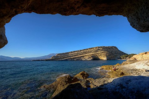 Neolithic caves, former hippie paradise, view from a cave of the deep blue sea and a rocky coast on