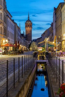Schlossstraße in the evening with castle church tower and Röhrwasser, Luther city Wittenberg,