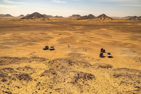 Off-road vehicle with tourists in the Black Desert in the Egyptian part of the Libyan Desert, Egypt