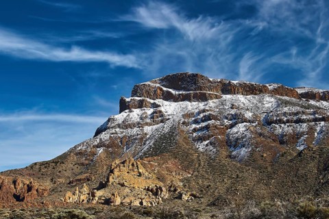 Near Ermita delas Nieves, impressive rock formation with remnants of snow against dramatic sky,