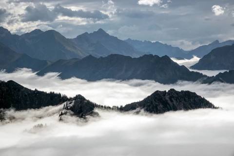 View from the Nebelhorn summit to mountains of the Allgäu Alps, mountains rising from fog in the