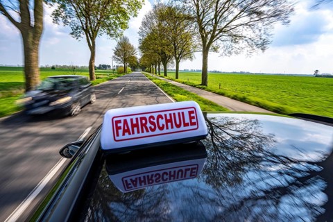 Symbolic picture driving school driving on a country road