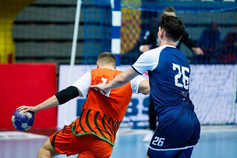 Backs of two handball players struggle during the match in Lubin, Poland