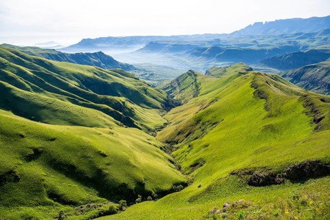 Green meadows and mountain valley, cathedral range mountain landscape, Drakensberg Mountains,