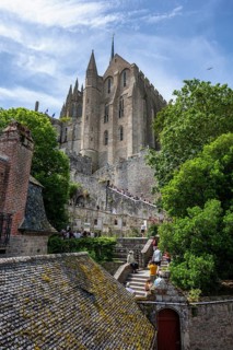 View over the stairway to Le Mont-Saint-Michel Abbey on Rocky Island, monastery island, tourist
