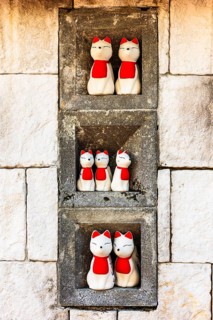 Maneki-neko Japanese-style cat figures in the Wat Phra That Don Phra Chan Buddhist temple, near