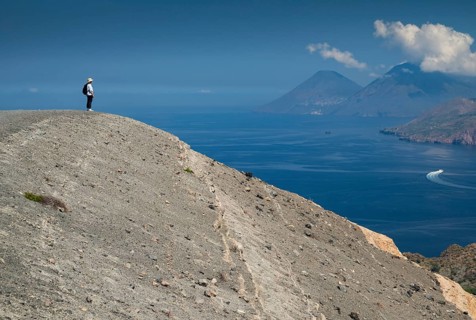Visitor standing at the crater rim, Vulcano, in the background Lipari and Salina, Aeolian or Lipari