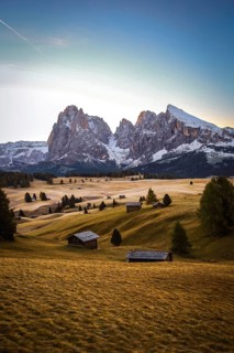 Light from sunrise on the mountains and quiet meadow landscape, view over the autumnal Seiser Alm