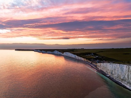 Sunset over Seven Sisters Cliffs from a drone, English Channel, East Sussex, South-east England