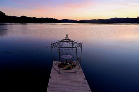 Table with two chairs on a pier at Lac d'Aiguebelette, Great Natural Lake, Aiguebelette-le-Lac,