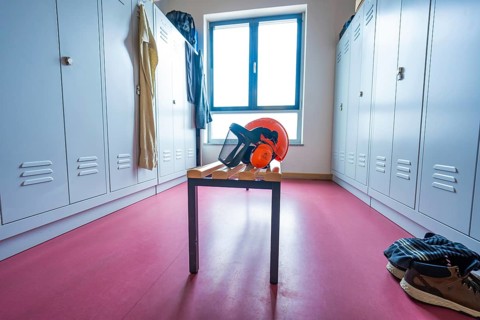 Changing room with lockers, window front and a table with helmet, Bauhof, Calw, Calw district,