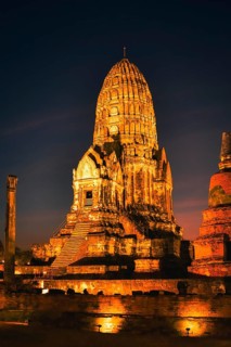 Wat Ratchaburana ancient temple in Ayutthaya, Thailand. Illuminated central prang and ruins under