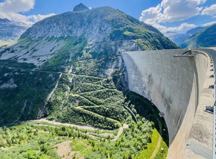 View of 200 meter high Kölnbrein dam facing away from the water with Airwalk viewing platform in