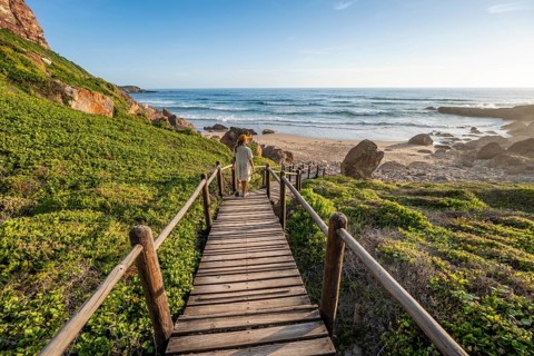 Woman on her way to the beach, coast and sea at Robberg Nature Reserve, Plettenberg Bay, South