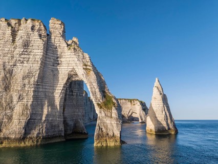 Aerial view of the Porte d'Aval rock formation with the free-standing Aiguille d'Étretat rock pin