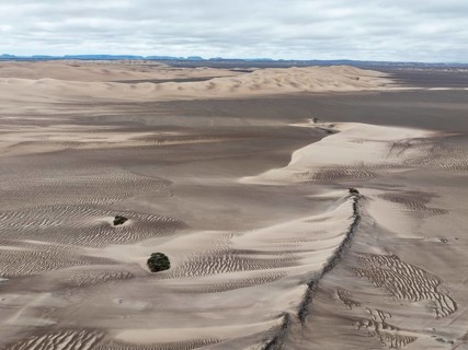 Barchan dunes and sand patterns at the edge of the Namib Desert. Aerial view. Drone shot. Skeleton