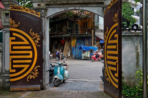A view from a historic temple courtyard of handcrafted bamboo ladders, metre-long bamboo poles,