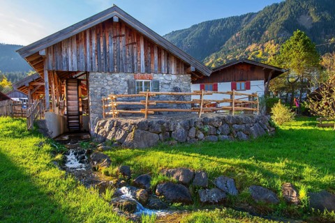 Historic Schleifmühle, water mill, in the village in spring, Ohlstadt, Loisach Valley, The Blue