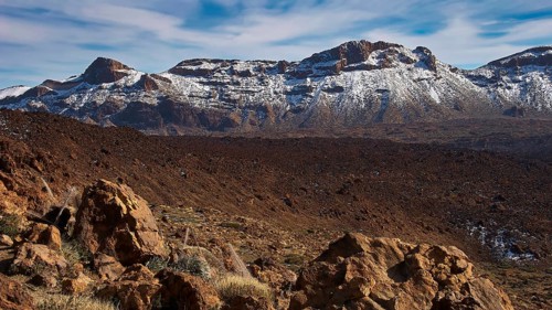 Mirador El Tabonal Negro, rock formations with snow on a mountain under blue sky, Teide, Parque