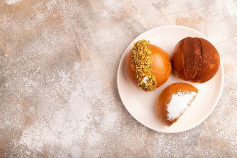 Maritozzo traditional Italian bun dessert, on brown concrete background, copy space, side view