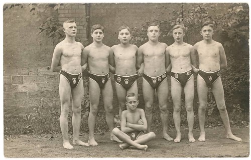 Bathing, swimwear, leisure, summer, Six boys and a little boy in swim shorts pose in front of a