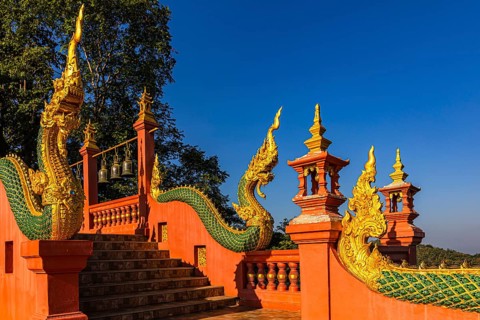 Gilded dragon figures on the stairway to the Buddhist temple Wat Phra That Don Phra Chan, near
